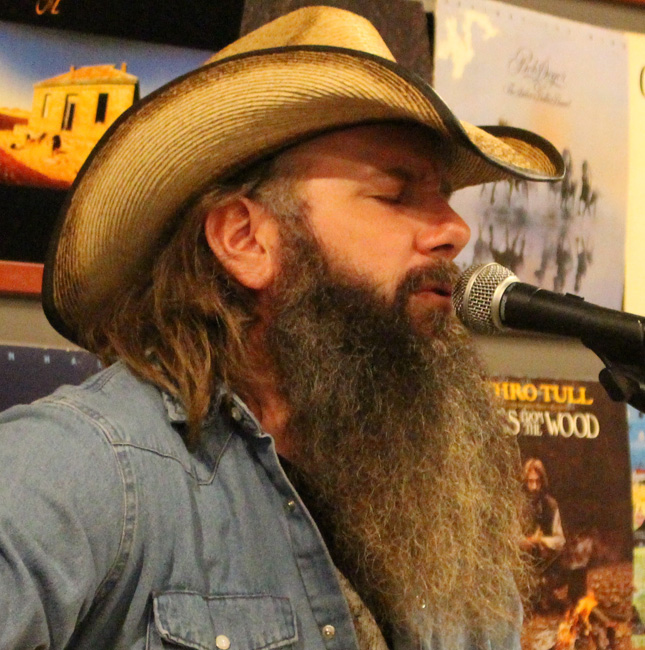 man with long beard wearing straw cowboy hat and jean shirt singing